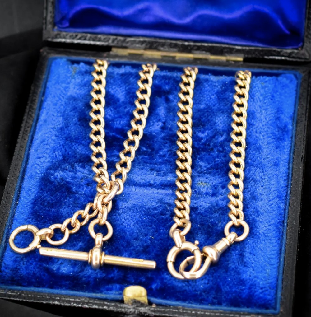 An antique 15ct yellow gold Albert chain necklace featuring curb links, a T-bar drop, a bolt ring, and a dog clip clasp. View VI