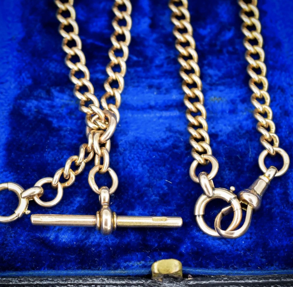 An antique 15ct yellow gold Albert chain necklace featuring curb links, a T-bar drop, a bolt ring, and a dog clip clasp. View VII