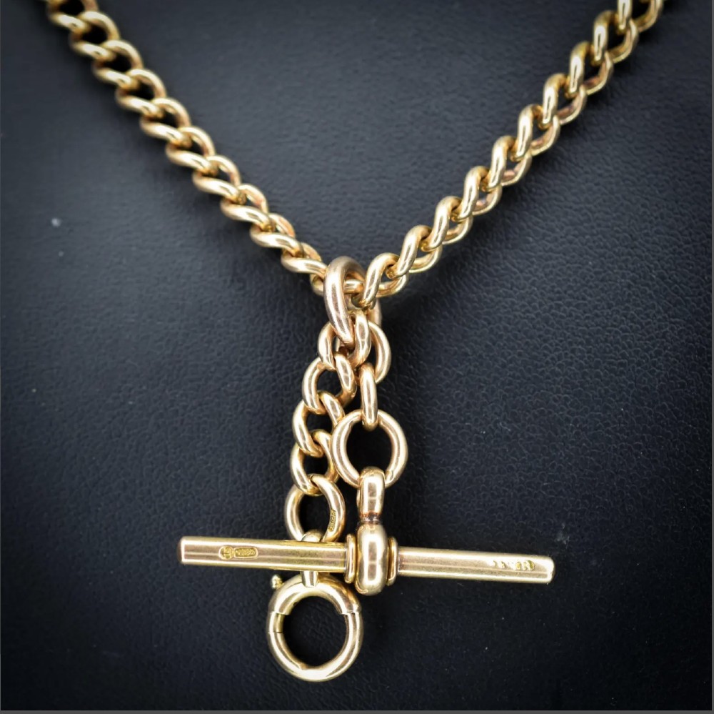 An antique 15ct yellow gold Albert chain necklace featuring curb links, a T-bar drop, a bolt ring, and a dog clip clasp. View VIII