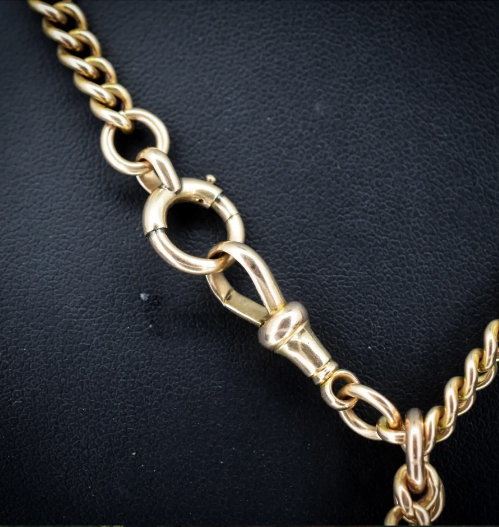 An antique 15ct yellow gold Albert chain necklace featuring curb links, a T-bar drop, a bolt ring, and a dog clip clasp. View IX