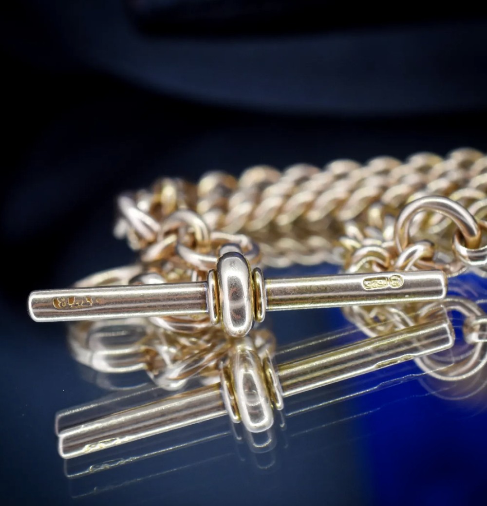 An antique 15ct yellow gold Albert chain necklace featuring curb links, a T-bar drop, a bolt ring, and a dog clip clasp. View XII