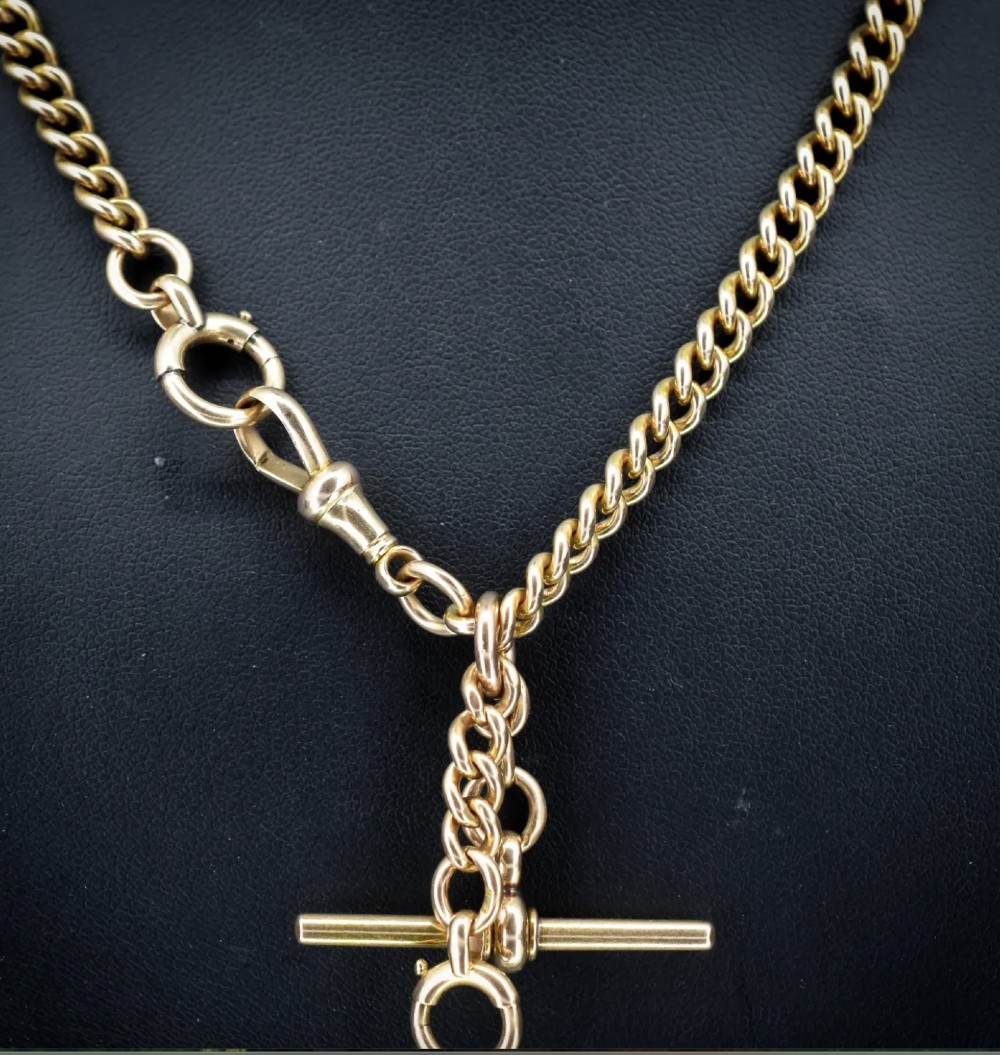 An antique 15ct yellow gold Albert chain necklace featuring curb links, a T-bar drop, a bolt ring, and a dog clip clasp. View XIV