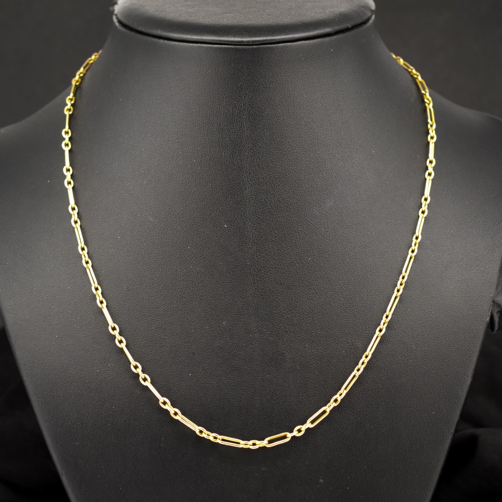 An antique 15ct yellow gold chain featuring alternating long trombone links and short oval links with a barrel clasp. View II