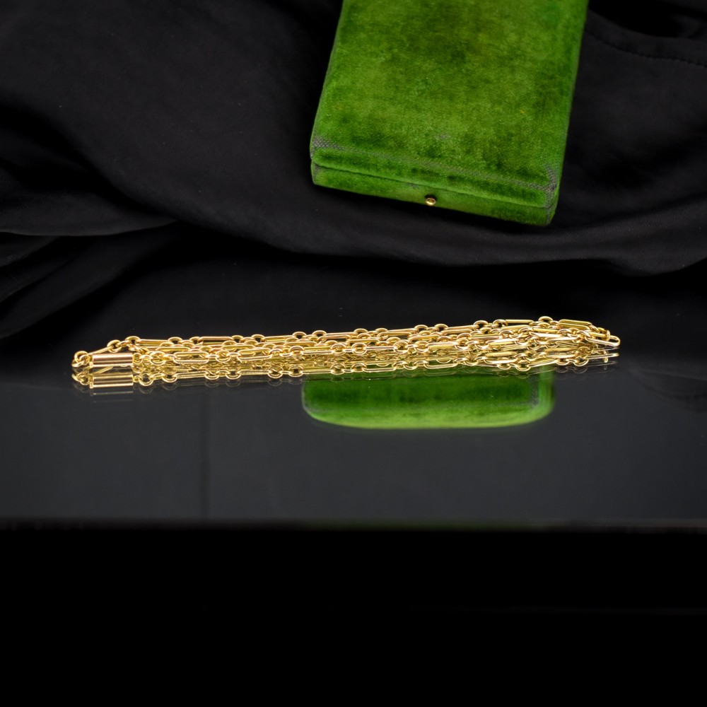An antique 15ct yellow gold chain featuring alternating long trombone links and short oval links with a barrel clasp. View VI