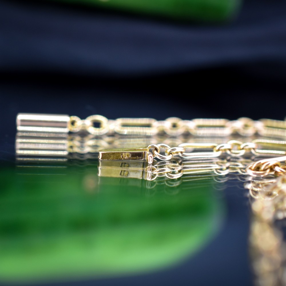 An antique 15ct yellow gold chain featuring alternating long trombone links and short oval links with a barrel clasp. View VIII
