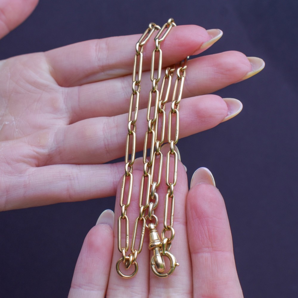 An antique 15ct yellow gold chain featuring alternating long trombone links and short oval links with a barrel clasp. View IX