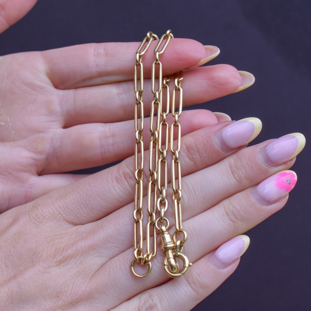 An antique 15ct yellow gold chain featuring alternating long trombone links and short oval links with a barrel clasp. View X