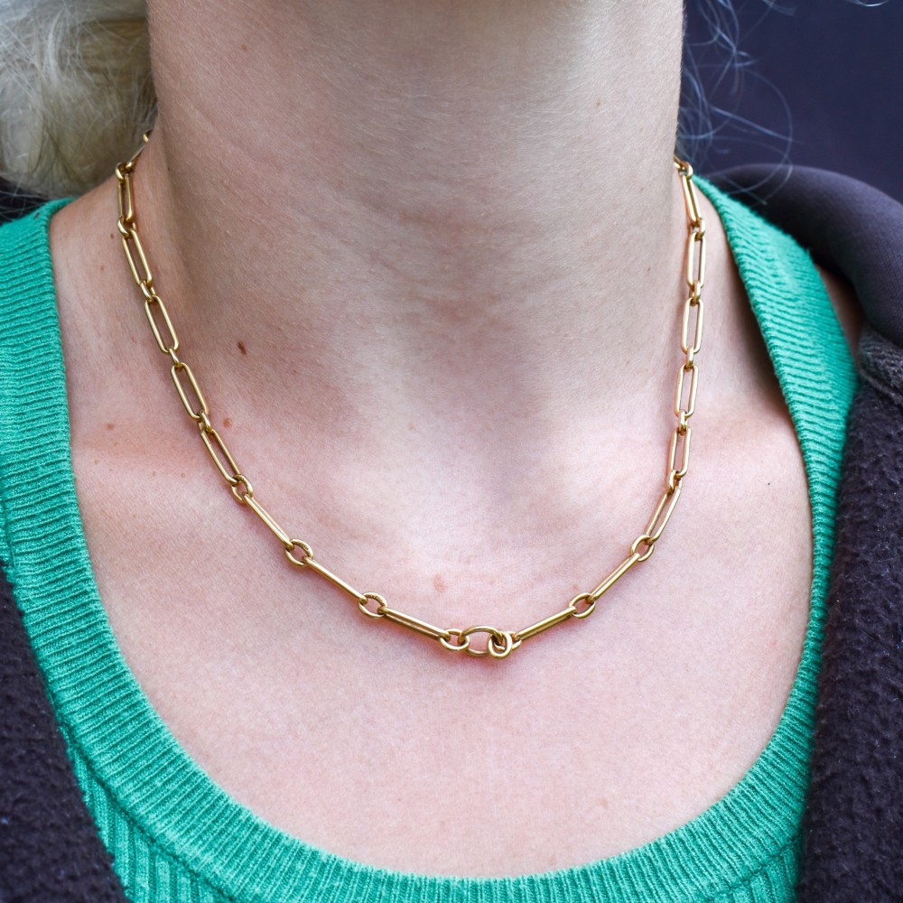 An antique 15ct yellow gold chain featuring alternating long trombone links and short oval links with a barrel clasp. View XI