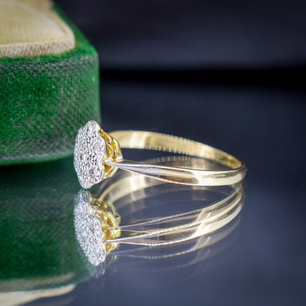 An antique 18ct yellow gold ring featuring a floral diamond cluster head set in platinum. View V