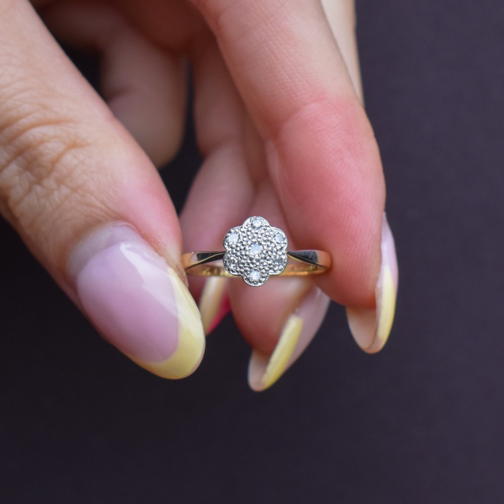 An antique 18ct yellow gold ring featuring a floral diamond cluster head set in platinum. View VII