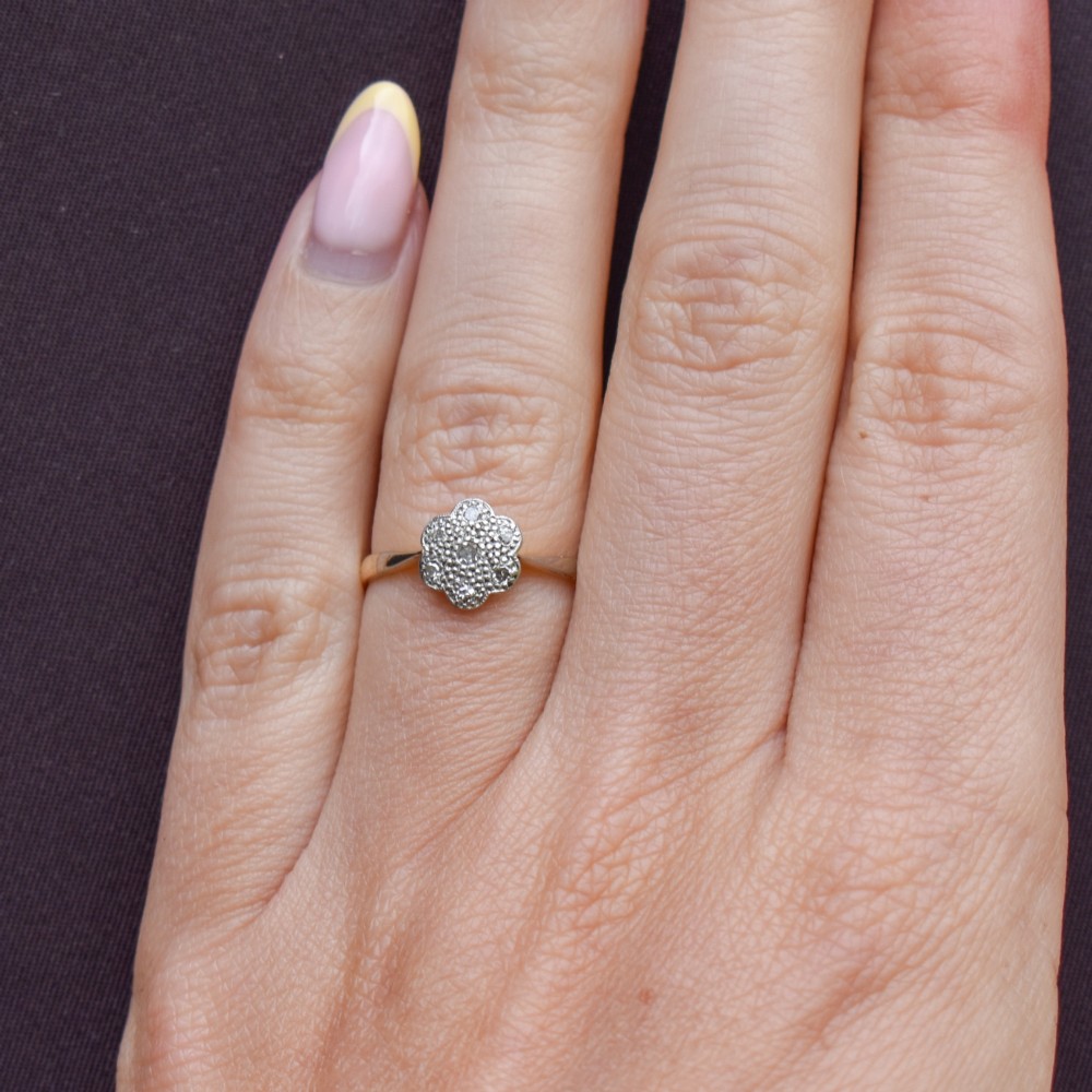 An antique 18ct yellow gold ring featuring a floral diamond cluster head set in platinum. View IX