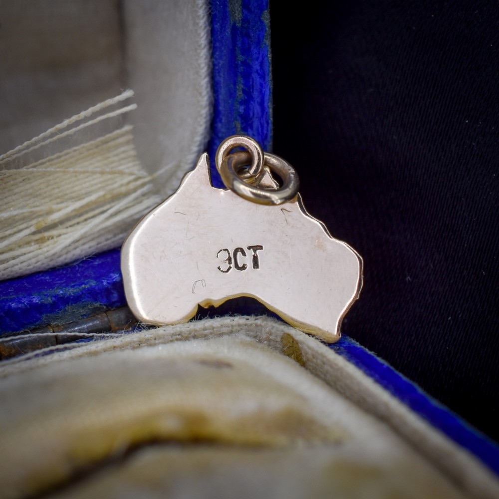 A 9ct yellow gold pendant in the shape of Australia, featuring a central bezel-set oval black opal triplet with blue and violet play-of-colour. View III
