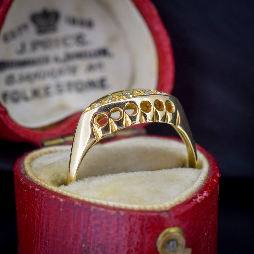 An 18ct yellow gold boat ring set with five graduated diamonds within a carved pierced gallery. View IV