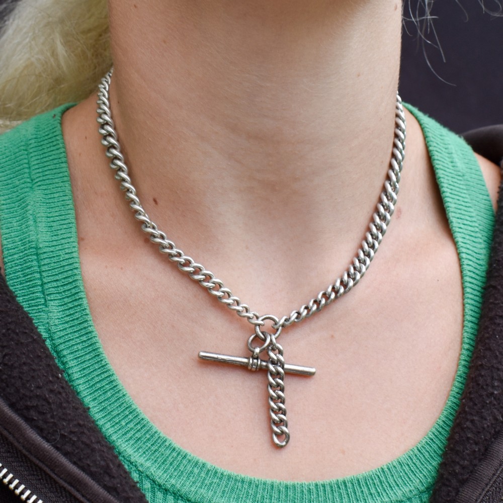 A sterling silver curb link double Albert pocket watch chain featuring a central T-bar. View V