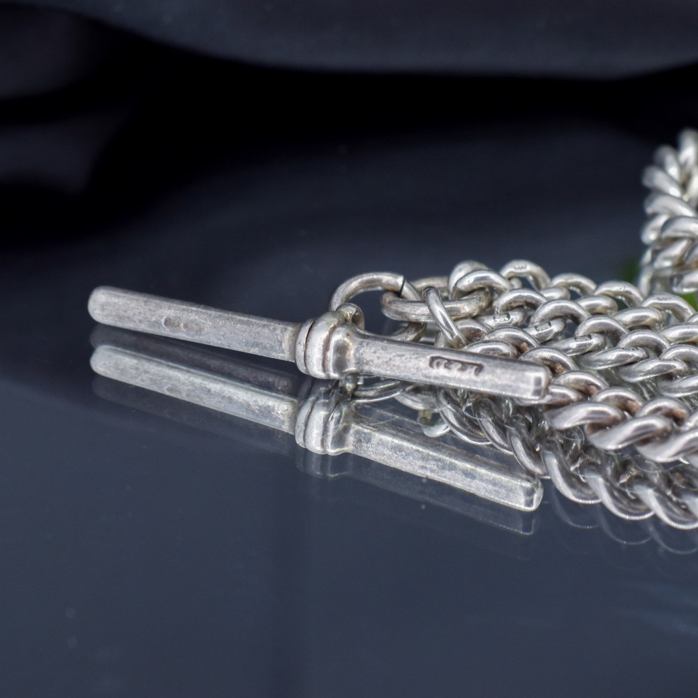 A sterling silver curb link double Albert pocket watch chain featuring a central T-bar. View XII