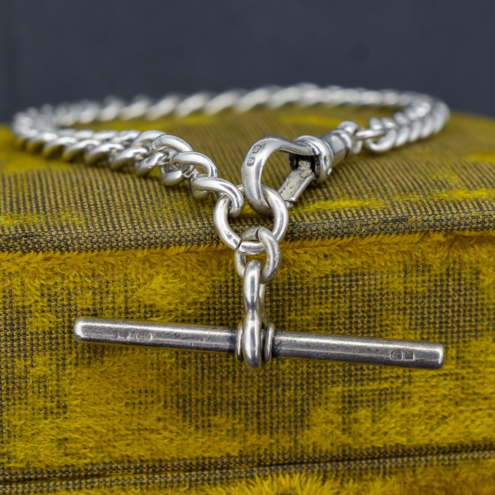 A sterling silver curb link chain bracelet featuring a swivel dog clip fastener and a T-bar pendant. View II