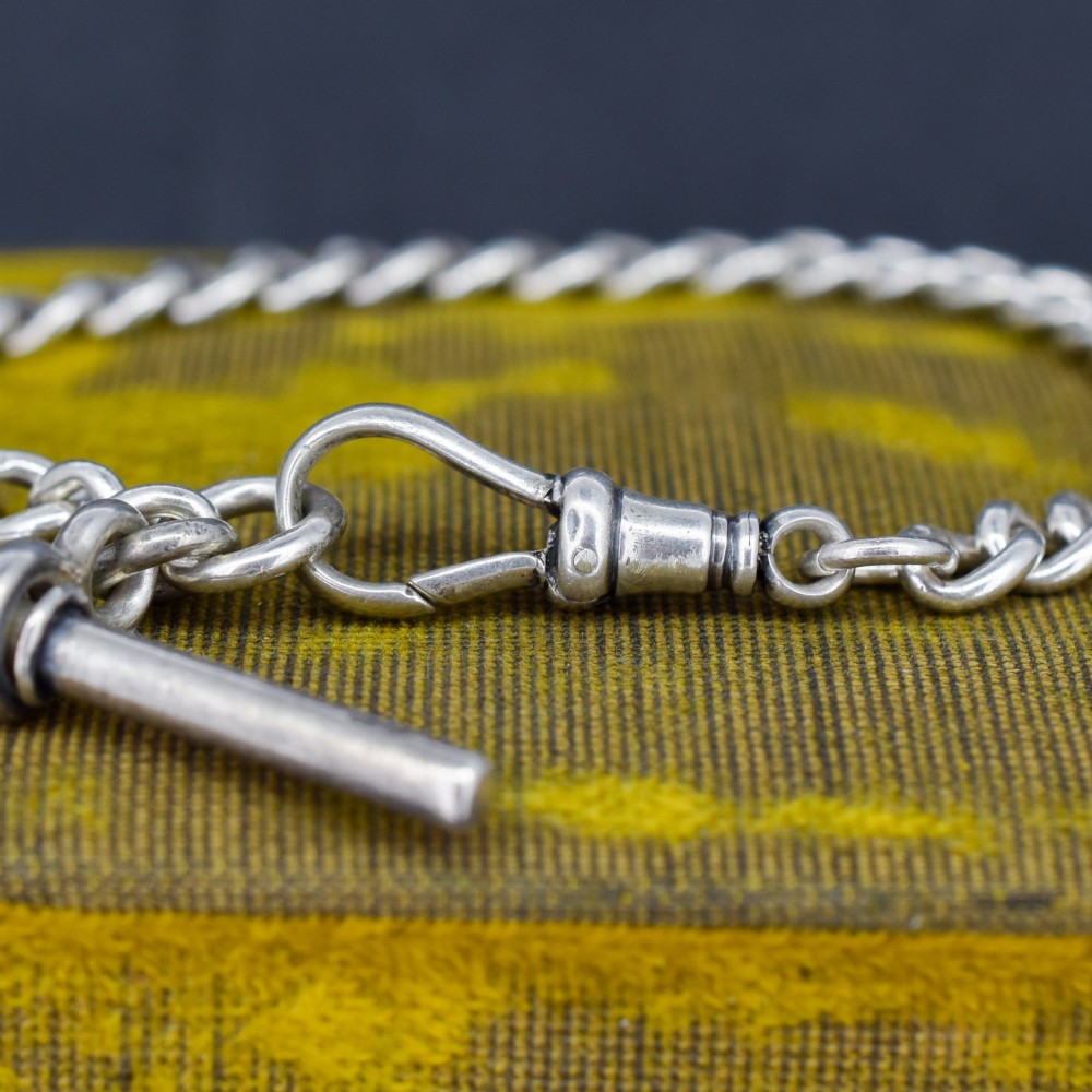 A sterling silver curb link chain bracelet featuring a swivel dog clip fastener and a T-bar pendant. View IV