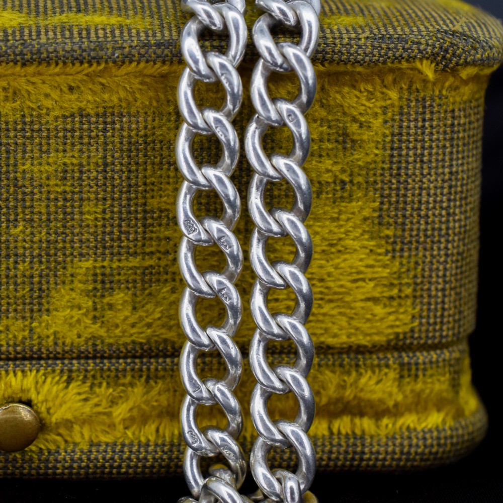 A sterling silver curb link chain bracelet featuring a swivel dog clip fastener and a T-bar pendant. View VII