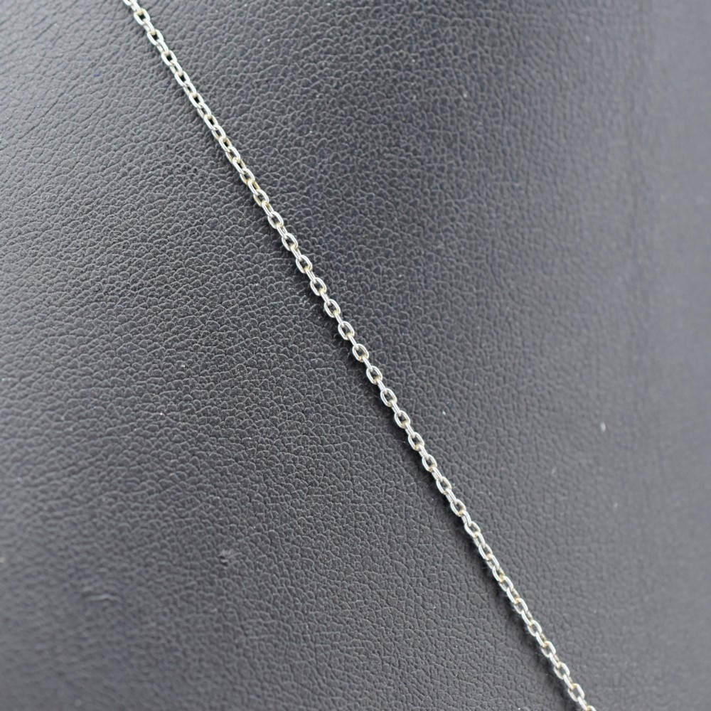 An Art Deco carved green jade pendant with geometric platinum and diamond accents on a chain. View III