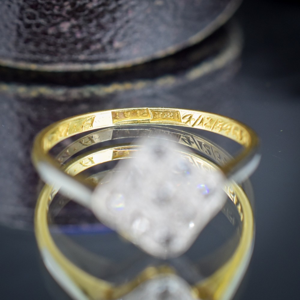An Art Deco 18ct yellow gold ring featuring a platinum square lozenge cluster set with multiple diamonds and fine millegrain details. View VII