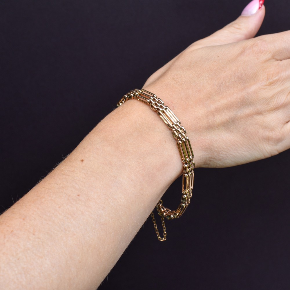 An antique rolled gold gate link bracelet featuring an engraved heart-shaped padlock clasp and safety chain. View X
