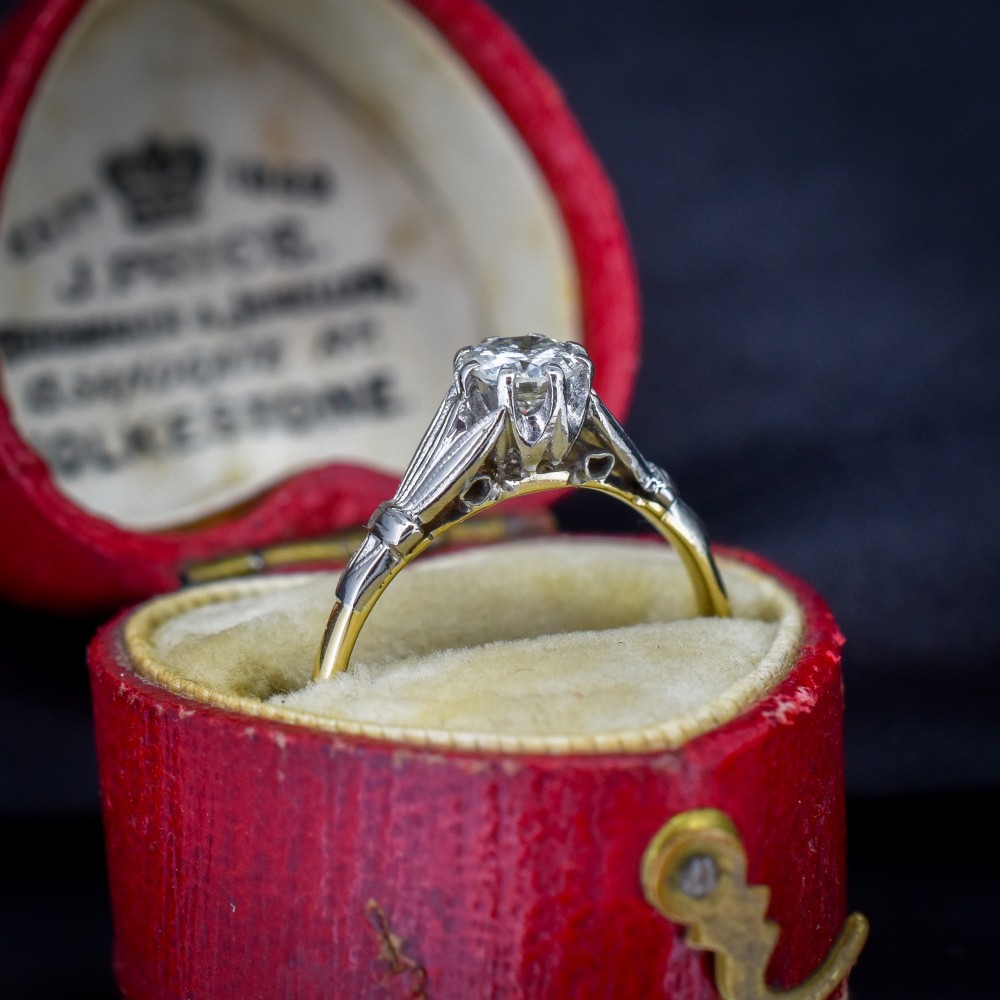 An Art Deco diamond solitaire ring featuring a round cut diamond set between detailed, fan-etched shoulders on an 18ct yellow gold band. View III