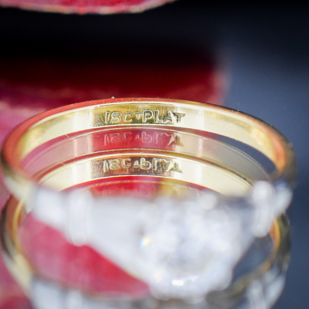 An Art Deco diamond solitaire ring featuring a round cut diamond set between detailed, fan-etched shoulders on an 18ct yellow gold band. View VIII