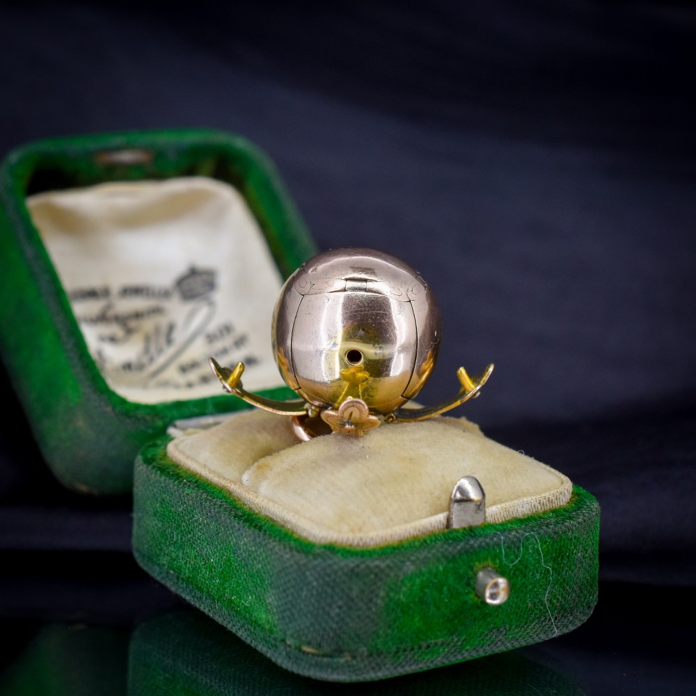 An antique spherical gold and silver Masonic ball charm featuring four chased outer arms and a top bail for suspension. View III