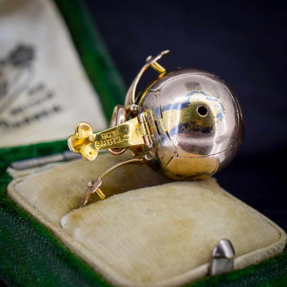 An antique spherical gold and silver Masonic ball charm featuring four chased outer arms and a top bail for suspension. View IV