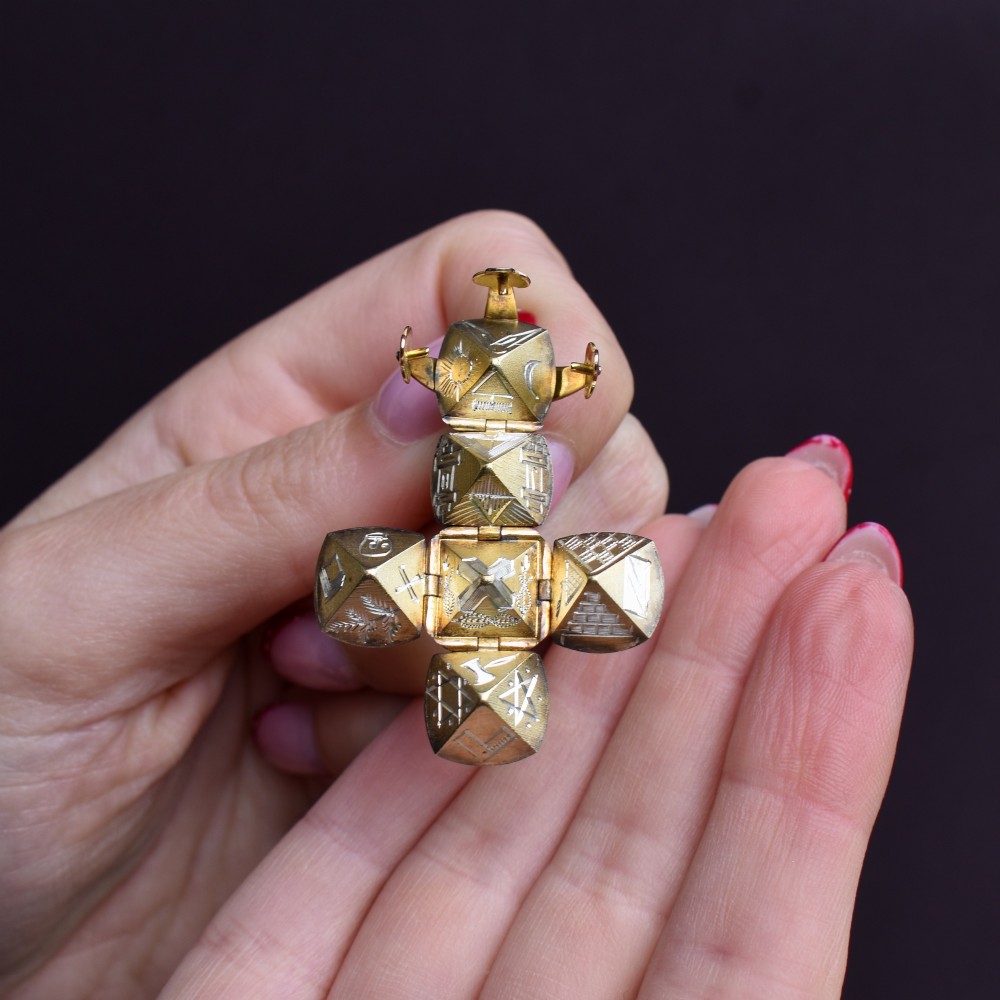 An antique spherical gold and silver Masonic ball charm featuring four chased outer arms and a top bail for suspension. View X