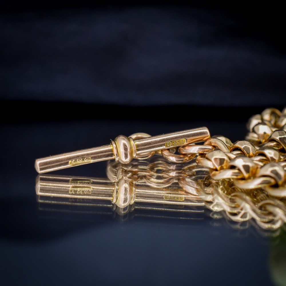 An antique 9ct yellow gold rollerball Albert chain featuring a central T-bar drop and double dog clip clasps. View VI