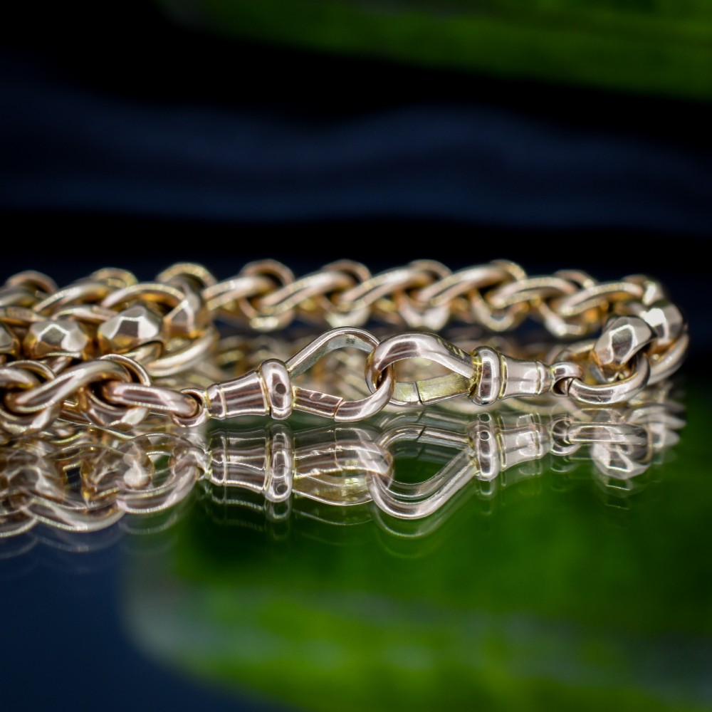 An antique 9ct yellow gold rollerball Albert chain featuring a central T-bar drop and double dog clip clasps. View VII