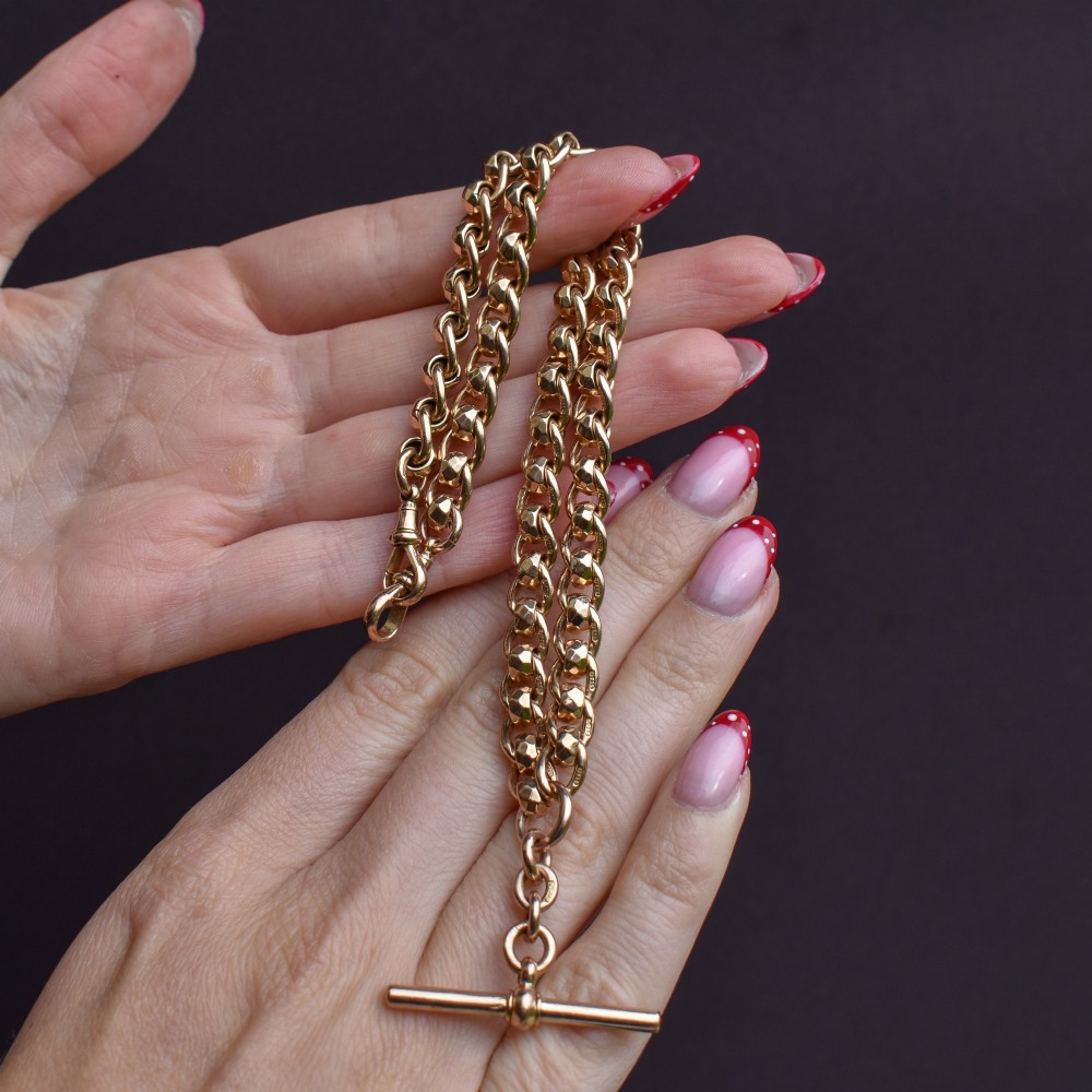 An antique 9ct yellow gold rollerball Albert chain featuring a central T-bar drop and double dog clip clasps. View IX