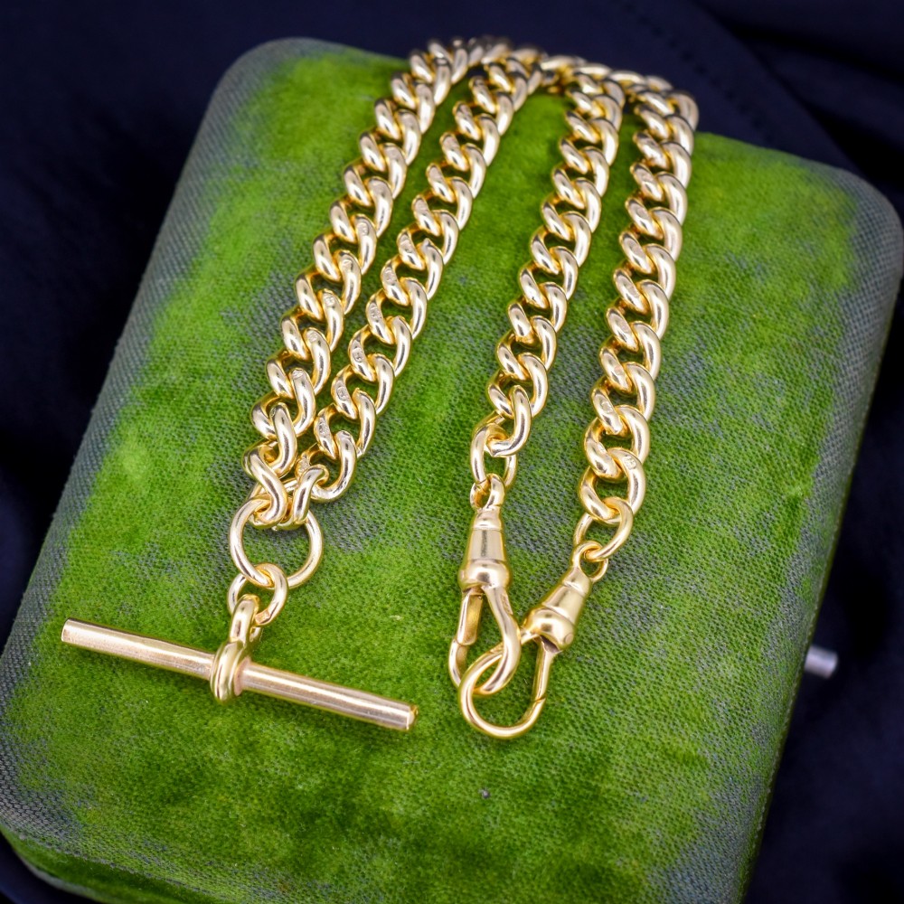 An antique gold-gilded sterling silver Albert watch chain featuring uniform curb links, a T-bar attachment, and dual swivel clasps.