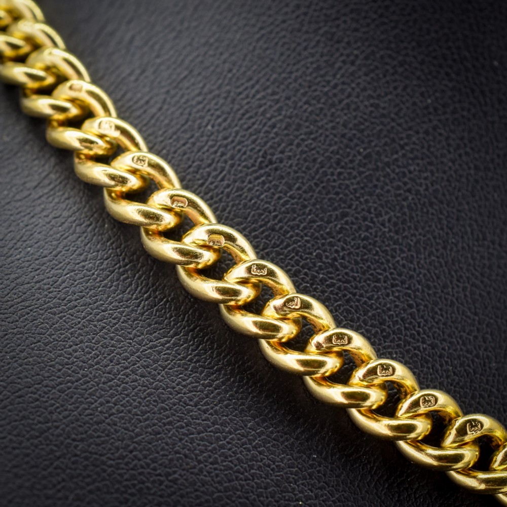 An antique gold-gilded sterling silver Albert watch chain featuring uniform curb links, a T-bar attachment, and dual swivel clasps. View IV