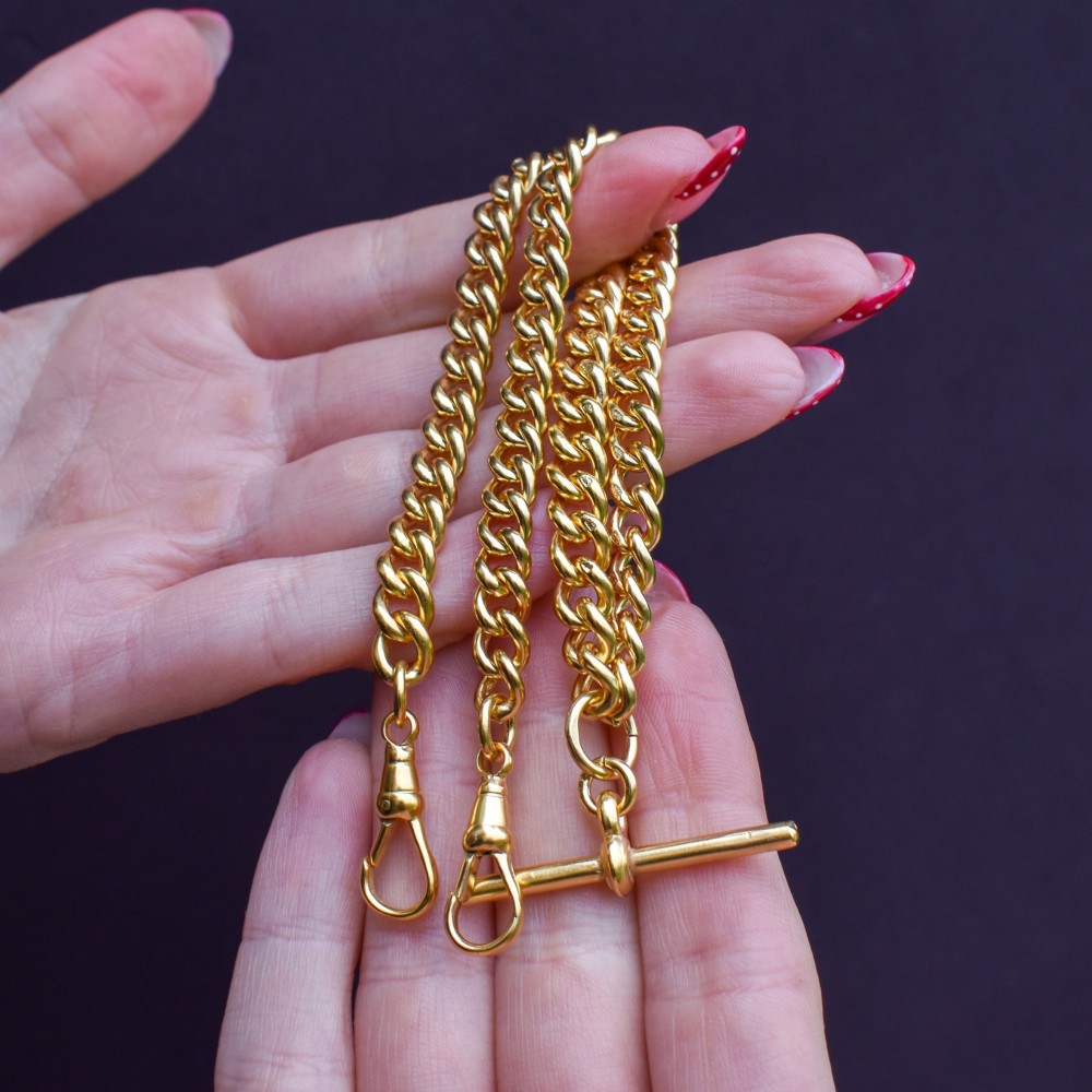 An antique gold-gilded sterling silver Albert watch chain featuring uniform curb links, a T-bar attachment, and dual swivel clasps. View VIII