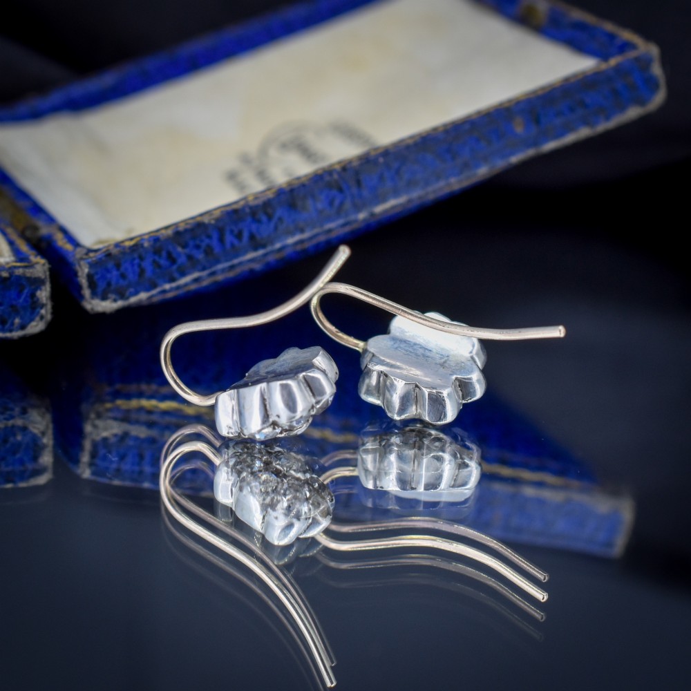 A pair of antique Georgian flower-shaped cluster earrings featuring clear paste stones set in silver with gold ear wires. View III