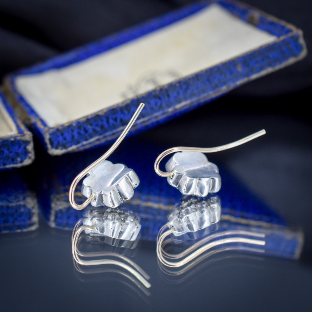 A pair of antique Georgian flower-shaped cluster earrings featuring clear paste stones set in silver with gold ear wires. View IV