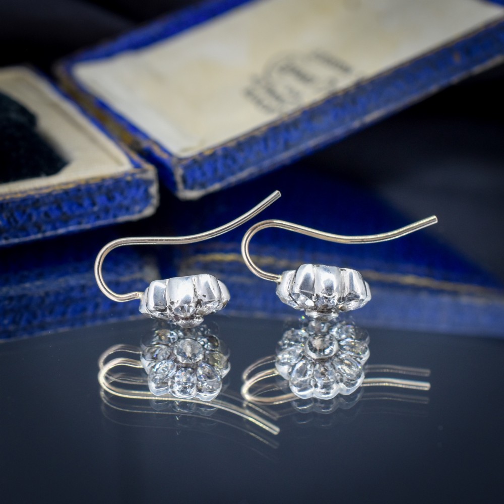 A pair of antique Georgian flower-shaped cluster earrings featuring clear paste stones set in silver with gold ear wires. View VI