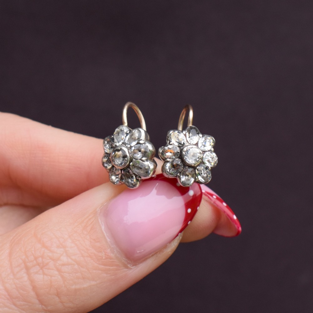 A pair of antique Georgian flower-shaped cluster earrings featuring clear paste stones set in silver with gold ear wires. View VII