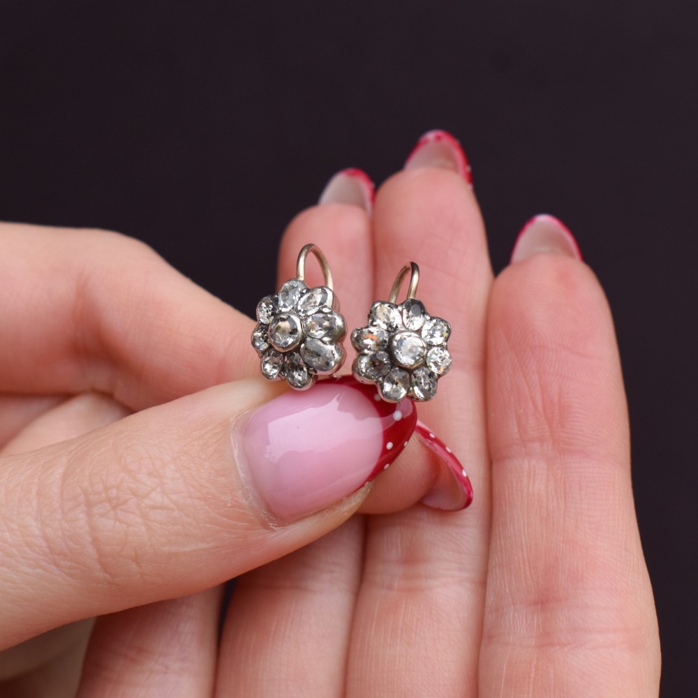 A pair of antique Georgian flower-shaped cluster earrings featuring clear paste stones set in silver with gold ear wires. View VIII
