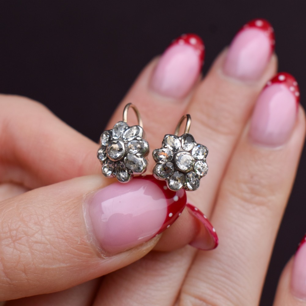 A pair of antique Georgian flower-shaped cluster earrings featuring clear paste stones set in silver with gold ear wires. View IX