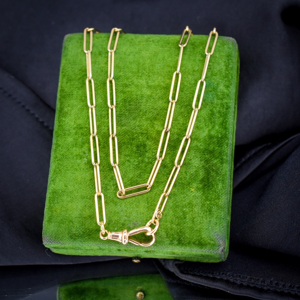 An antique 9ct yellow gold chain featuring elongated paperclip links and a swivel dog clip clasp.