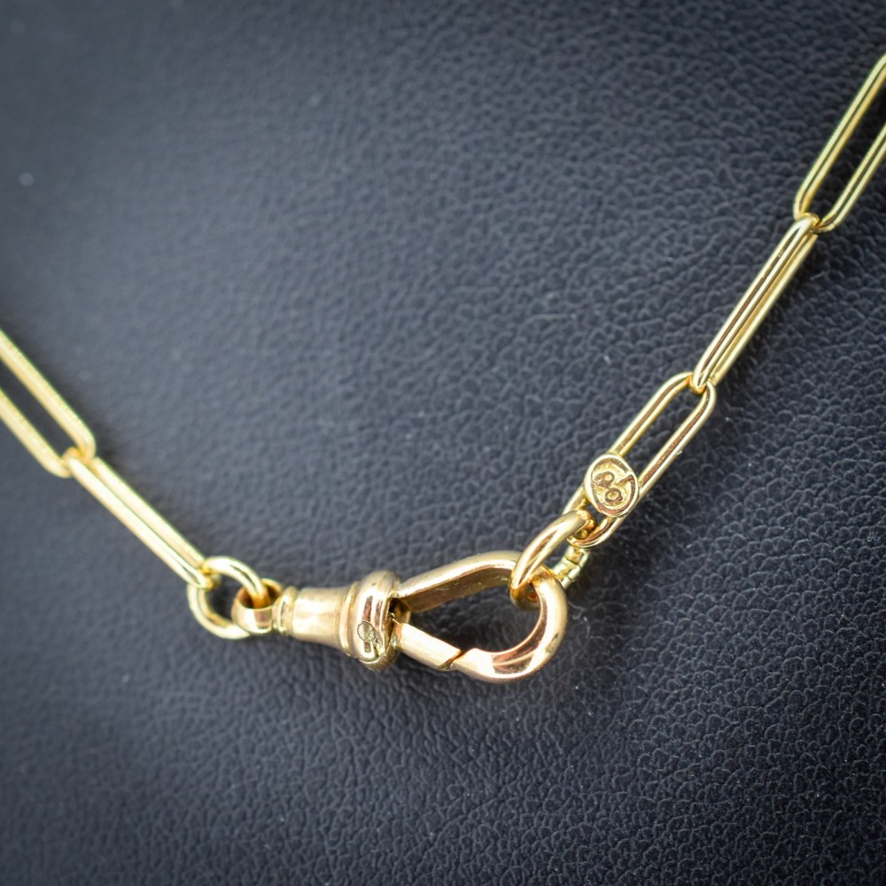 An antique 9ct yellow gold chain featuring elongated paperclip links and a swivel dog clip clasp. View IV