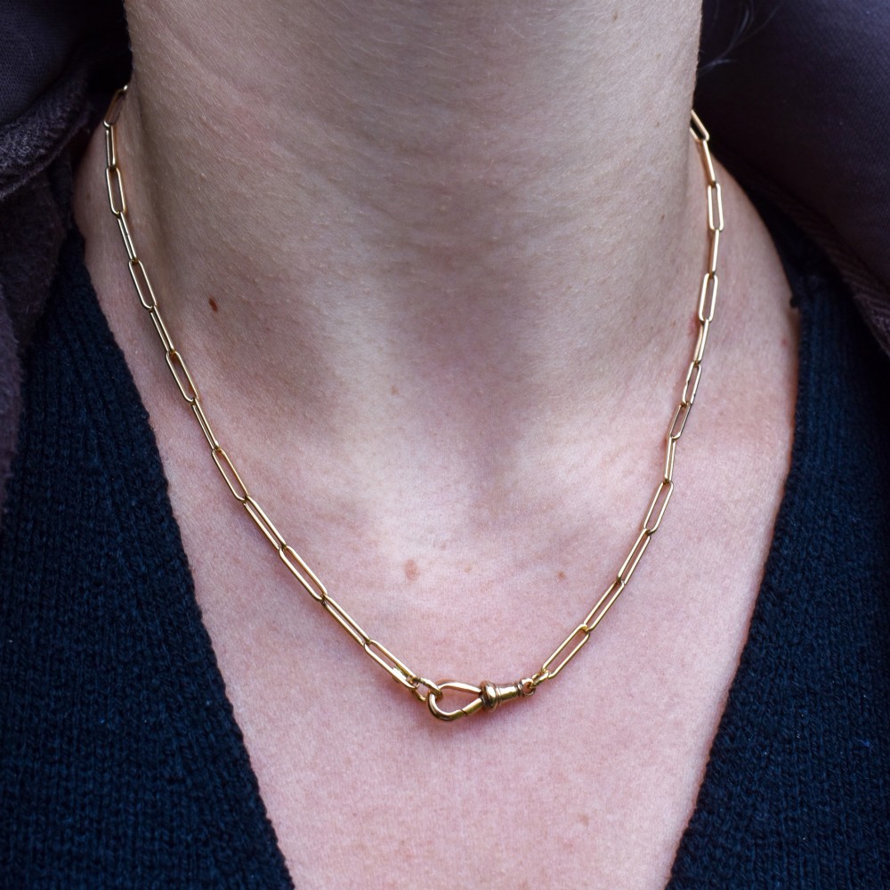 An antique 9ct yellow gold chain featuring elongated paperclip links and a swivel dog clip clasp. View IX