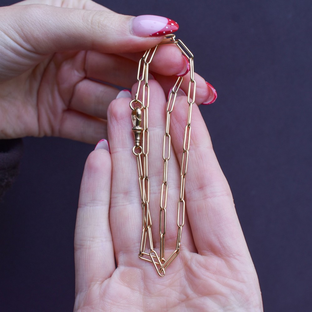An antique 9ct yellow gold chain featuring elongated paperclip links and a swivel dog clip clasp. View X