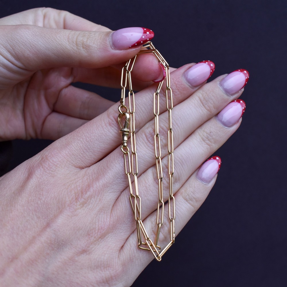 An antique 9ct yellow gold chain featuring elongated paperclip links and a swivel dog clip clasp. View XI