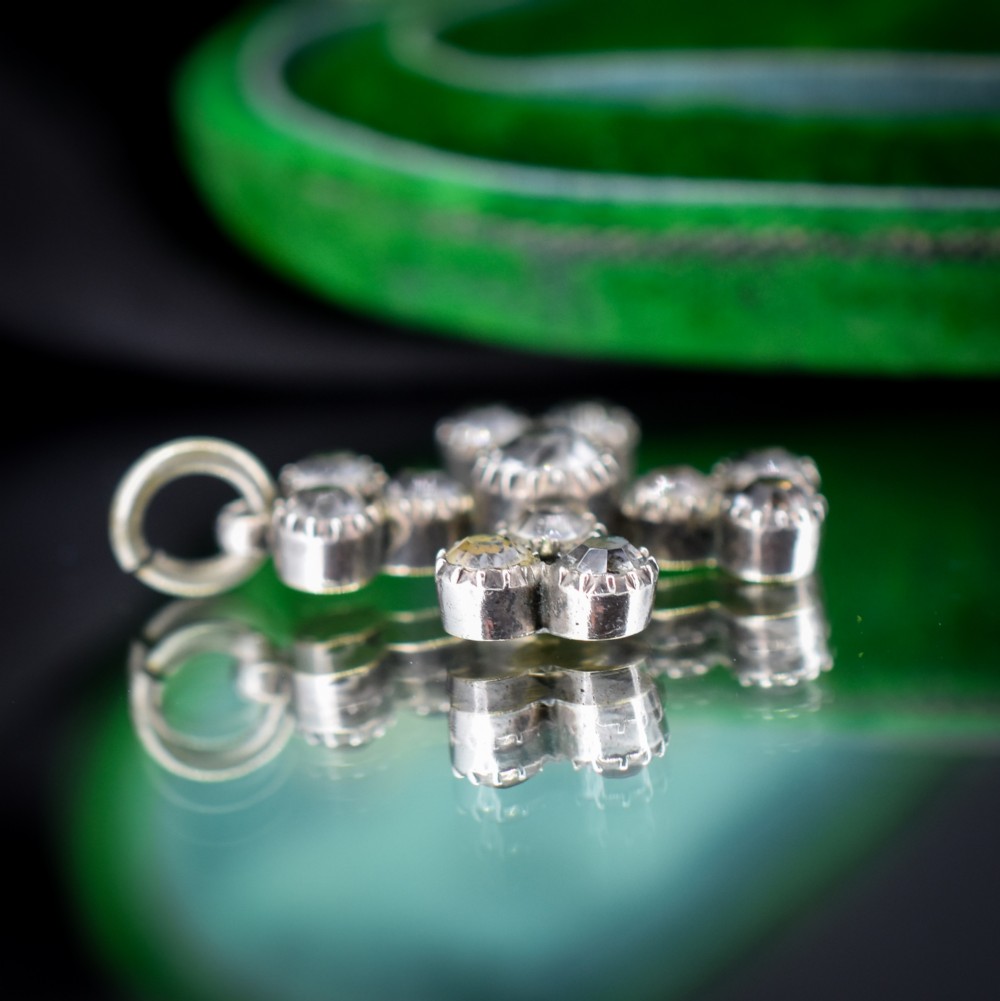 A Georgian silver bottony cross pendant set with clear faceted paste stones featuring black dot culets. View V