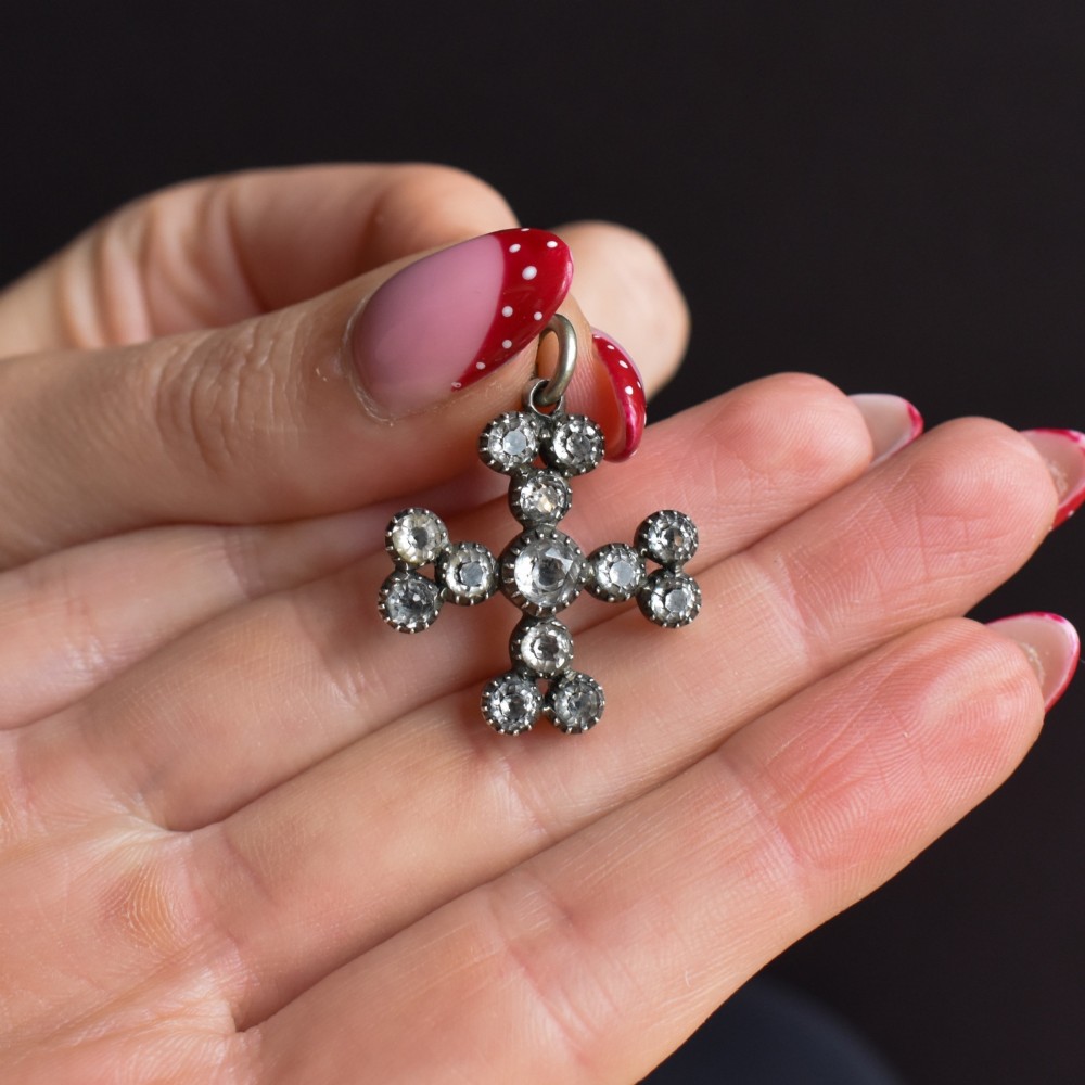 A Georgian silver bottony cross pendant set with clear faceted paste stones featuring black dot culets. View VII