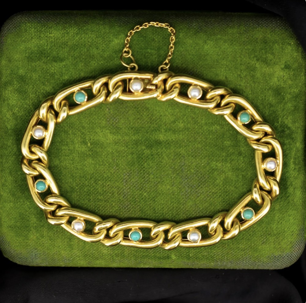 An antique 15ct yellow gold curb link bracelet inset with alternating pearls and cabochon turquoise stones, featuring a fitted safety chain.